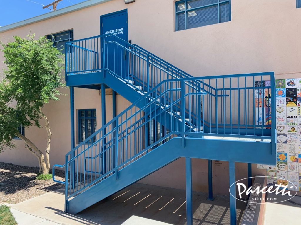 custom commercial steel stair system with integrated railings pre-cast concrete treads and perforated steel stair treads