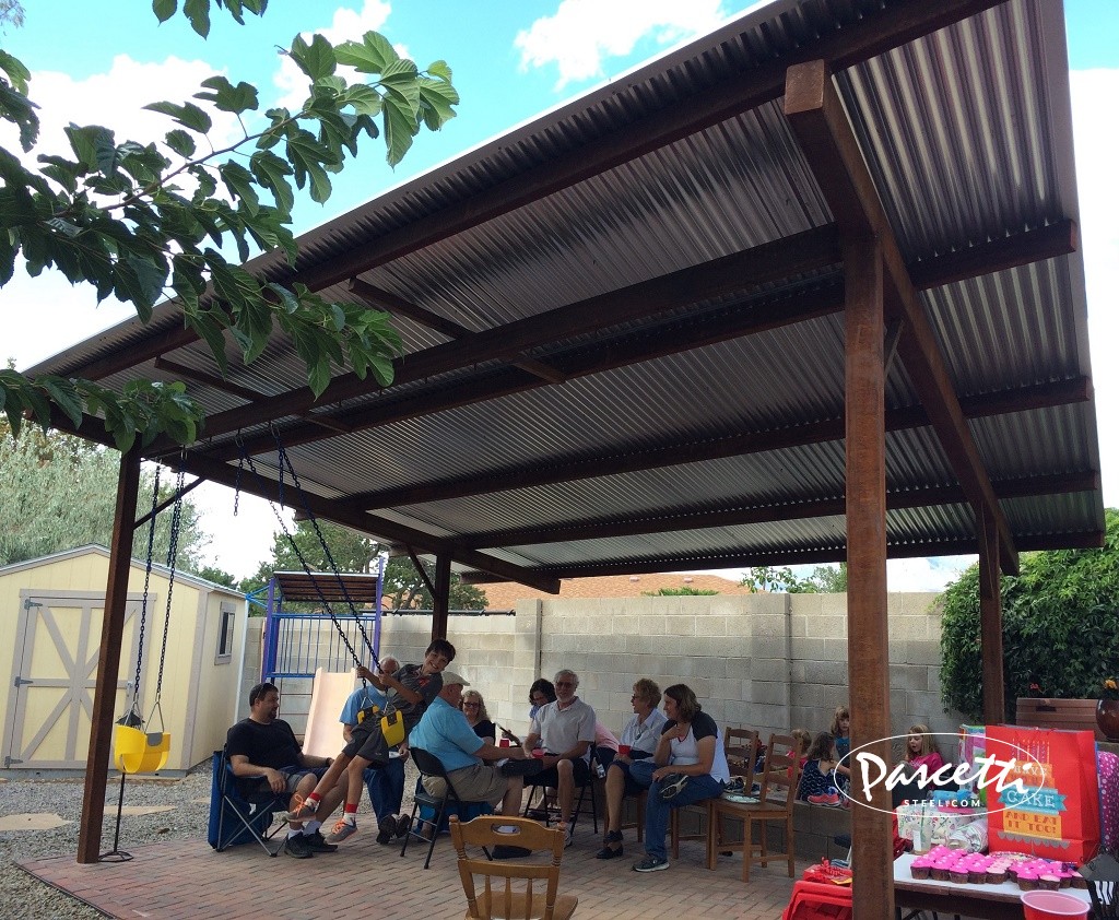 large steel shade structure with swings